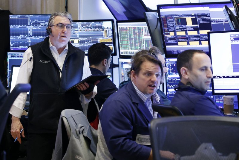 Traders work on the floor of the New York Stock Exchange on Wall Street on Thursday. Stocks rose Friday. Photo by John Angelillo/UPI